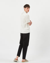 Load image into Gallery viewer, back view of the Minimum Men&#39;s Jole Shirt in White Asparagus on a model posing looking over his shoulder
