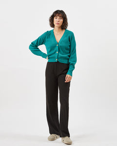 the Minimum Women's Cardine Cardigan in Bayou on a model posing with her hand on her hip