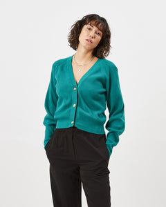 the Minimum Women's Cardine Cardigan in Bayou on a model posing with her hands in her pocket