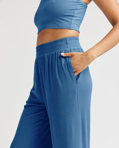 close up of side view of model wearing the Richer Poorer Women's Night Knit Pant in Blue Horizon posing with her hand in the pocket