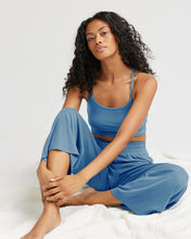 Load image into Gallery viewer, model seated against a white background wearing the Richer Poorer Women&#39;s Night Knit Pant in Blue Horizon with her knees bent
