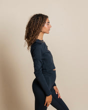 Load image into Gallery viewer, side view of a model wearing the Girlfriend Collective ReSet Long Sleeve Tee in Black
