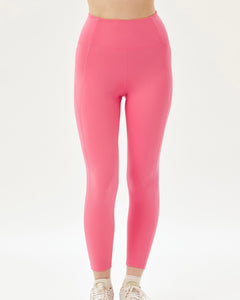 close up of the front of the Girlfriend Collective High-Rise Crop Legging in Camellia on a model