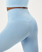 Load image into Gallery viewer, close up back view of the Girlfriend Collective High-Rise Crop Legging in Cerulean
