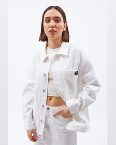 Dr. Denim Women's Ina Jacket in White on a model posing with her hand in her pant pocket