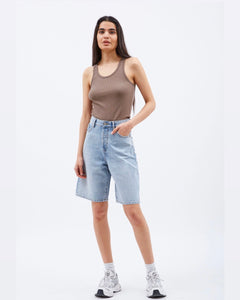 Dr. Denim Women's Bella Shorts in Bleach Sky on a model posing with one hand in her pocket