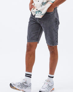 a close up of a model wearing the Dr. Denim Men's Dash Shorts in Night Grey Vintage