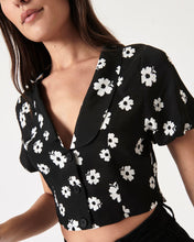 Load image into Gallery viewer, a close up of the front angled view of the Rolla&#39;s Folk Floral Susie Top in Black on a model
