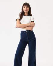 Load image into Gallery viewer, the Rolla&#39;s Women&#39;s Sailor Pant in Francoise worn by a model posing with her arms crossed
