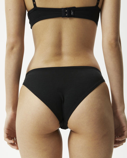 close up of the back of the Afends Women's Lolly Brief in Black on a model