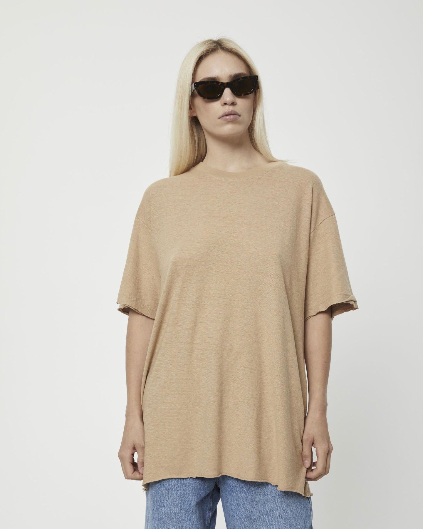 the Afends Women's Slay Oversized Tee in Tan on a model