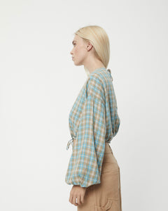 side view of a model wearing the Afends Women's Millie Blouse in Tan Check