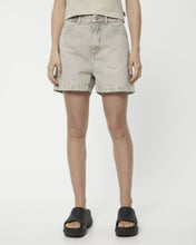 Load image into Gallery viewer, the Afends Women&#39;s Seventy Threes Denim Shorts in Faded Cement on a model
