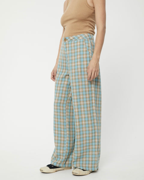 close up view of a model standing on an angle wearing the Afends Women's Millie Sienna Pant in Tan Check