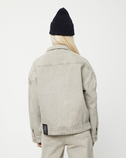 the back view of the Afends Innie Denim Jacket in Faded Cement on a model