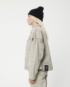 the Afends Innie Denim Jacket in Faded Cement on a model posing to the side