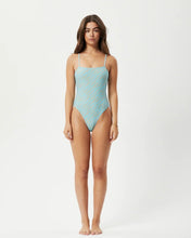 Load image into Gallery viewer, the Afends Adi Swimsuit in Blue Stripe on a model standing staring into the camera
