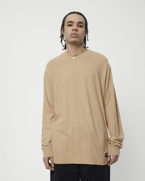 the Afends Men's Essential Long Sleeve Tee in Tan on a model