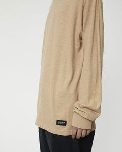 close up of the sleeve of the Afends Men's Essential Long Sleeve Tee in Tan on a model