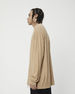 side view of the Afends Men's Essential Long Sleeve Tee in Tan on a model