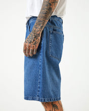 Load image into Gallery viewer, close up of the side view of the Afends Men&#39;s Lil C Denim Short in Authentic Blue on a model
