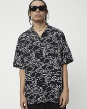 Load image into Gallery viewer, a close up of the Afends Men&#39;s Script Short Sleeve Cuban Shirt in Black Camo on a model
