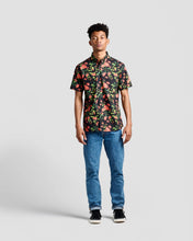 Load image into Gallery viewer, the Poplin &amp; Co Men&#39;s Short Sleeve Printed Shirt in Retro Floral worn by a model standing straight on facing the camera against a neutral background
