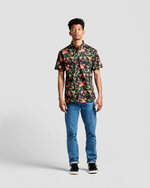 the Poplin & Co Men's Short Sleeve Printed Shirt in Retro Floral worn by a model standing straight on facing the camera against a neutral background