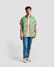 Load image into Gallery viewer, the Poplin &amp; Co Men&#39;s Short Sleeve Printed Shirt in Watermelon worn open over a t-shirt and jeans by a model standing looking straight at the camera against a neutral background
