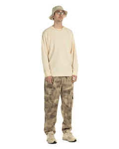 the Taikan Cargo Pants in Abstract Camo on a model standing with his hands by his sides