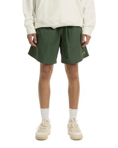 the front view of the Taikan Nylon Shorts in Forest Green laying worn by a model