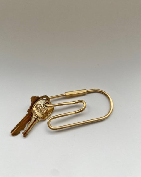 overhead shot of Belt Loop Key Chain in Brass with two keys against a neutral background