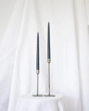 Load image into Gallery viewer, a pair of Socco Designs Taper Candles in charcoal in two tapers of varying heights against a white sheet background
