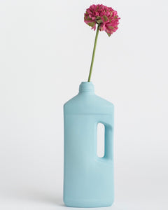 Middle Kingdom Motor Oil Bottle Vase with a pink flower