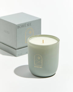 Boheme Fragrances Istanbul Candle sitting in front of it's box on a white surface