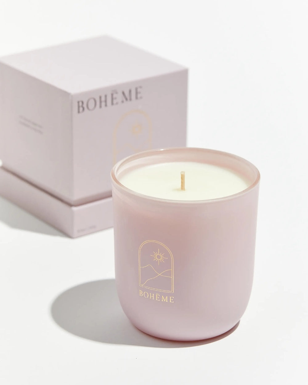 Boheme Fragrances Notting Hill Candle sitting in front of it's box on a white background
