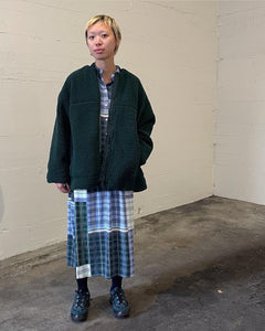 model standing facing the camera wearing the Minimum Women's Bavory Jacket in Pine Grove over a matching plaid blouse and skirt