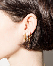 Load image into Gallery viewer, Hunt of Hounds Serpent Hoop Earrings in Silver stacked on a model&#39;s ear with gold hoops
